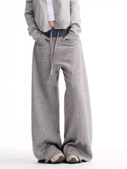 Grey wide-leg sweatpants with drawstring waist and pockets.