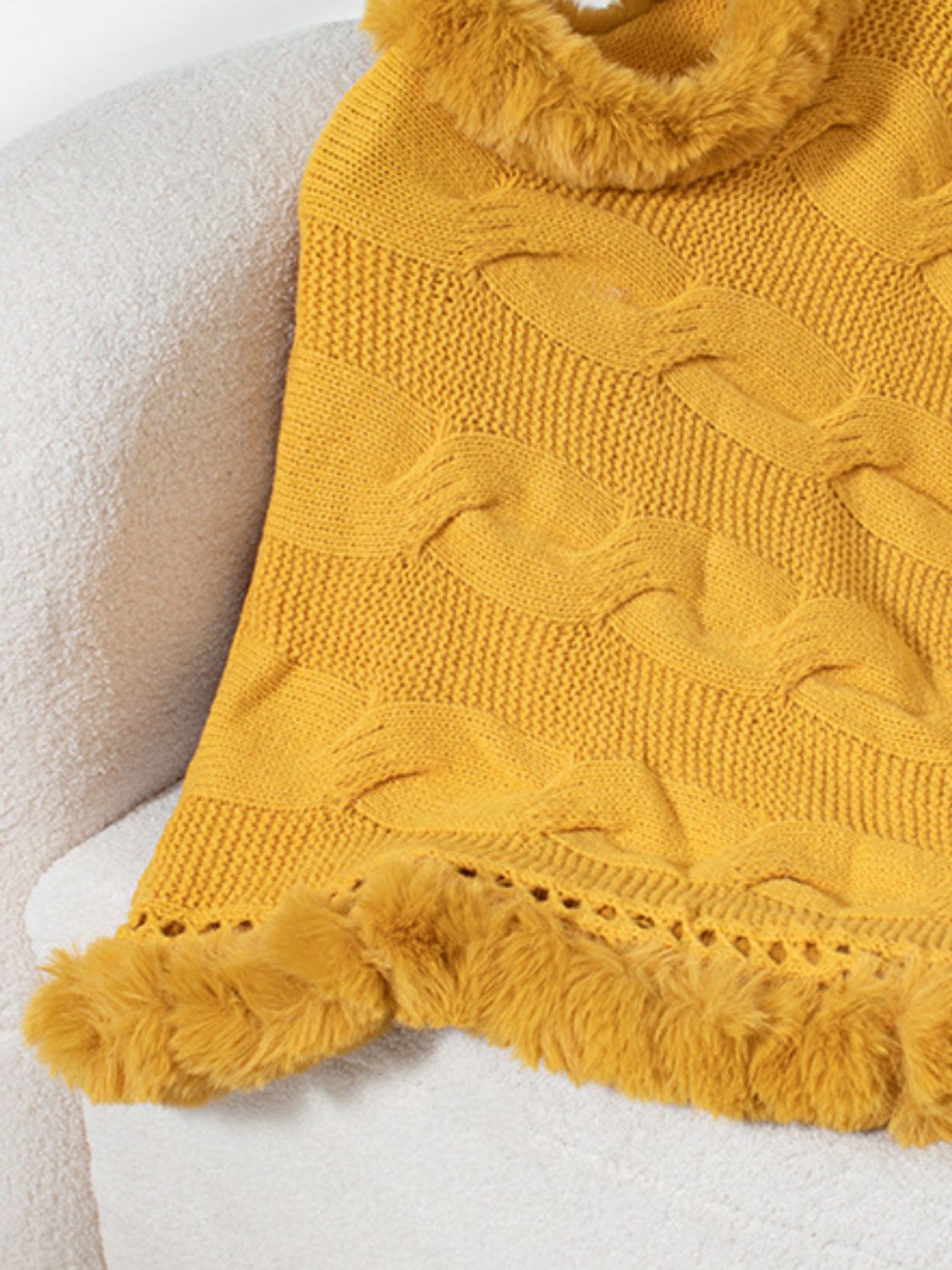 Gold cable knit poncho with faux fur trim and open knit detail