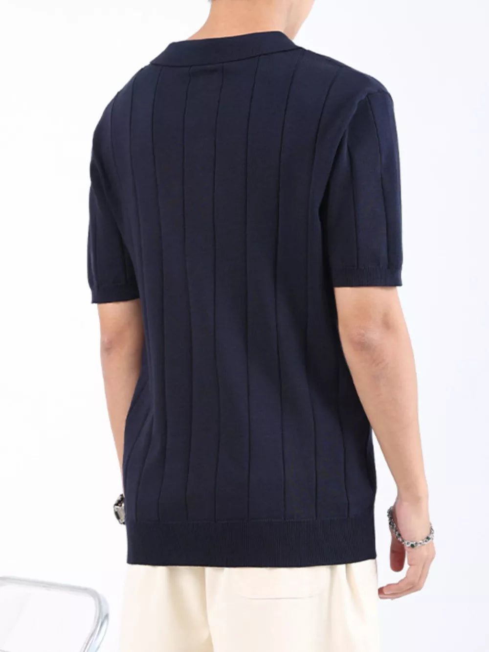 Men's navy ribbed knit polo shirt with short sleeves and classic collar.