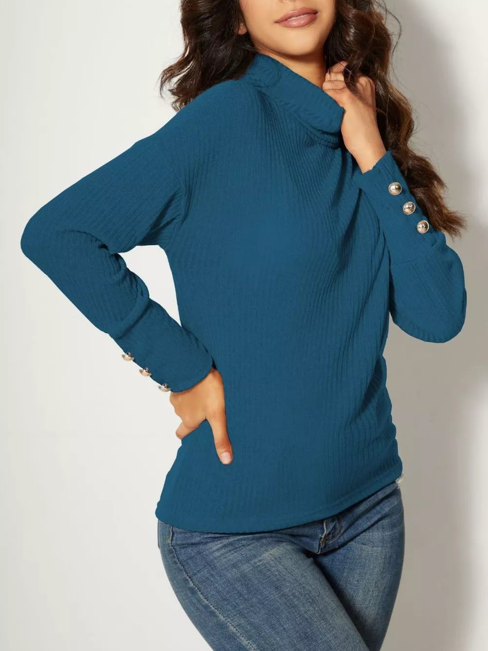 Blue ribbed turtleneck tunic top with decorative buttons on the cuff.