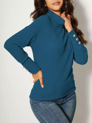 Blue ribbed turtleneck tunic top with decorative buttons on the cuff.