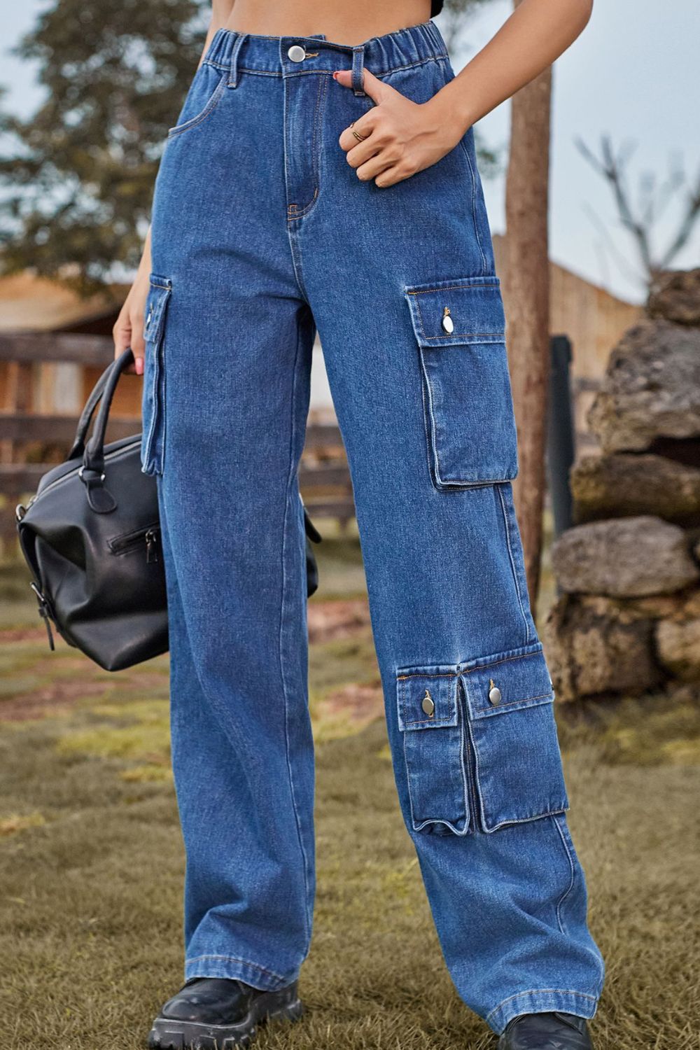 Relaxed wide leg denim cargo pants in medium blue with multiple utility pockets.