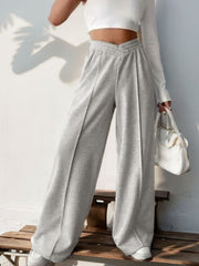 Light gray V-waistline pleated palazzo trousers with a comfortable, wide-leg fit.