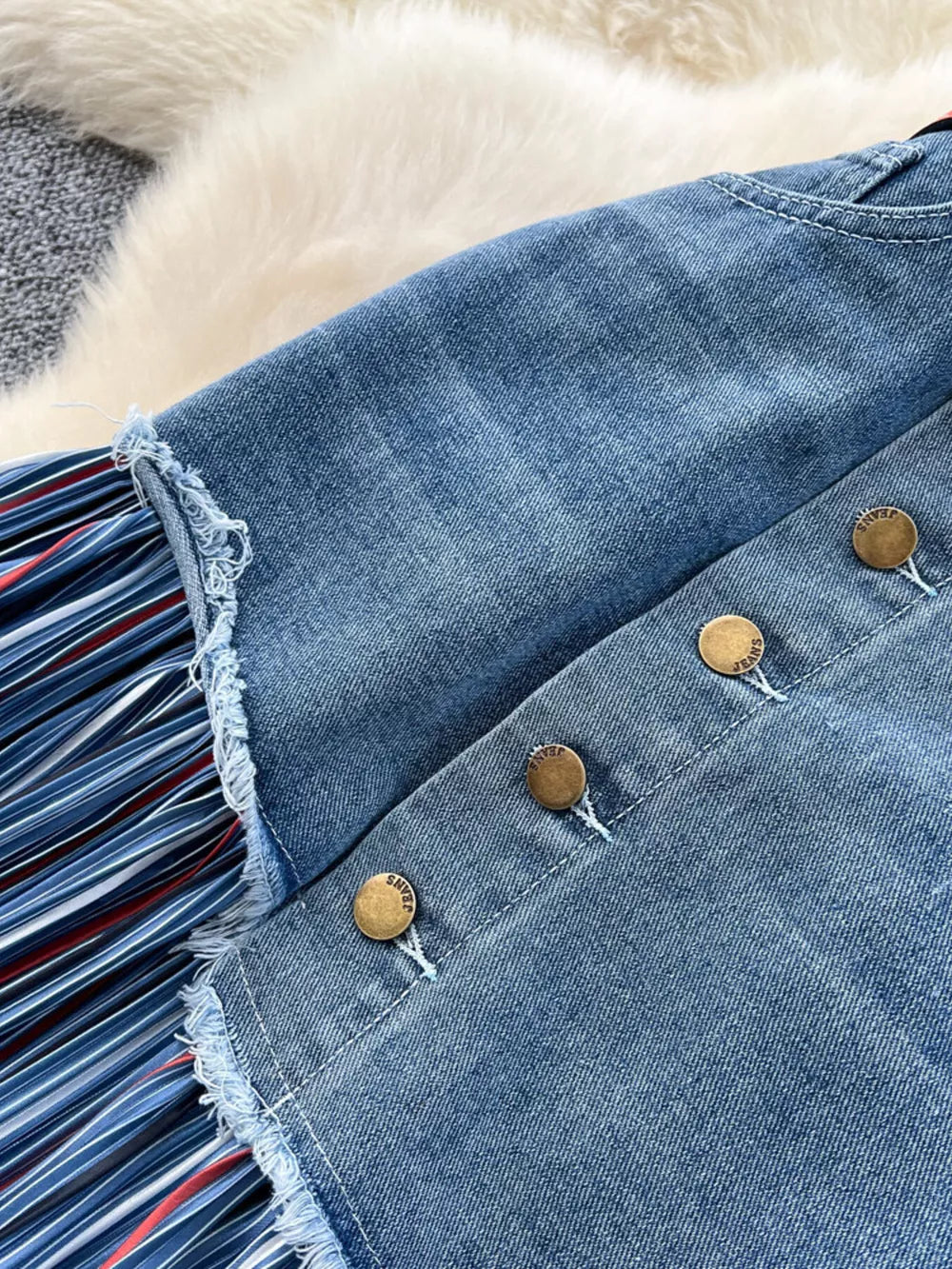 Patchwork denim midi skirt with striped detail and button front.