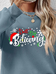 Air Force Blue long sleeve sweater with "Don't Stop Believing" graphic and Santa hat detail.