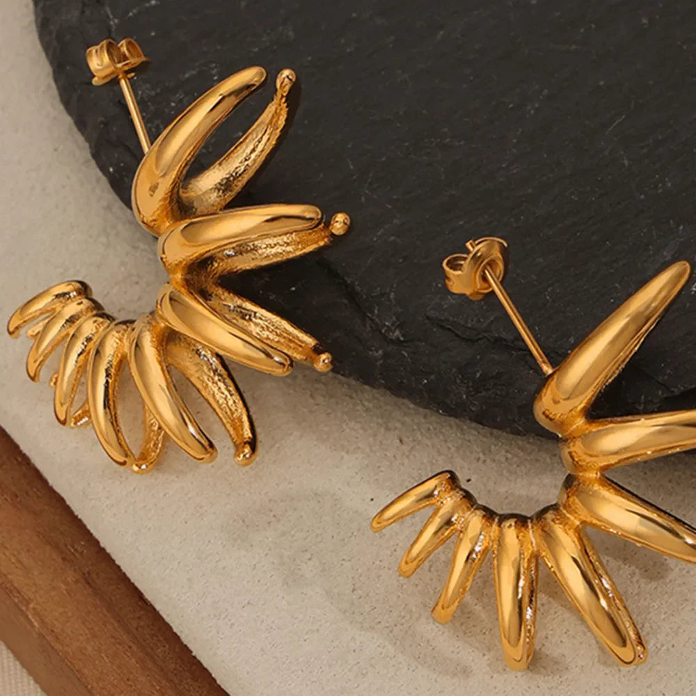 Gold sculptural petal drop earrings with unique, modern design.