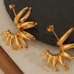 Gold sculptural petal drop earrings with unique, modern design.