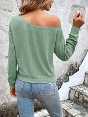 Light green off-shoulder eyelet knit top with long sleeves and a relaxed fit.
