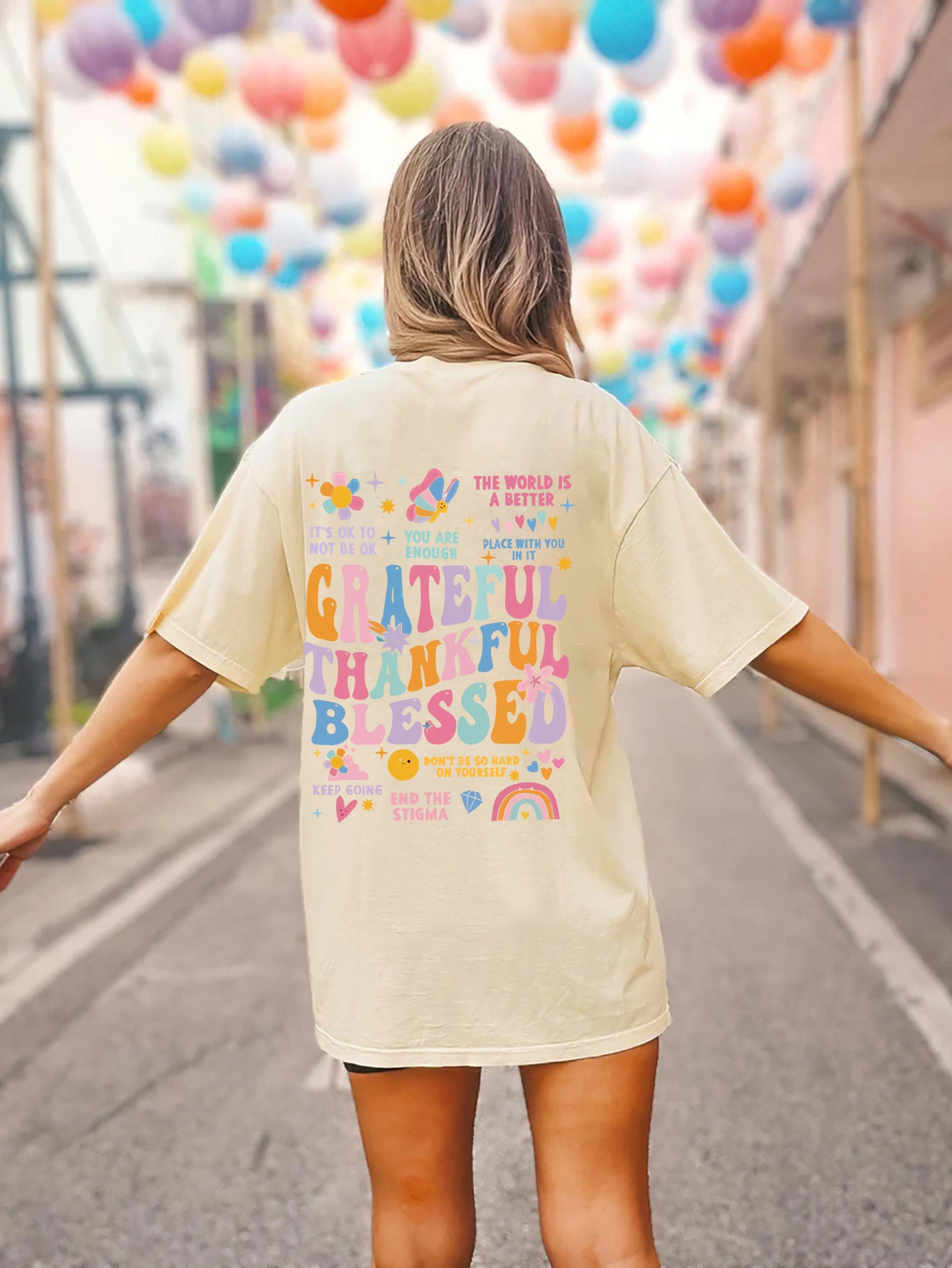 Cream vintage wash t-shirt with colorful graphic text and affirmations on back.