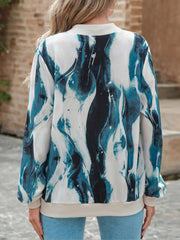 Fluid abstract bomber jacket in teal and white with a crew neck and ribbed cuffs.