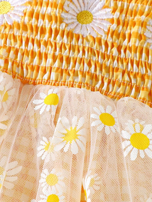 Daisy-embellished gingham ruffle one-piece with smocked bodice and sheer daisy print skirt.