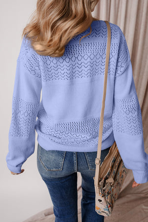 Light blue perforated knit v-neck pullover sweater with open knit details on sleeves and back.