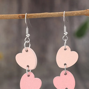 Cascading heartwood dangle earrings in blush pink with silver hooks.