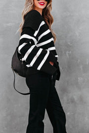 Black and white striped knit sweater with wide collar and bell sleeves.