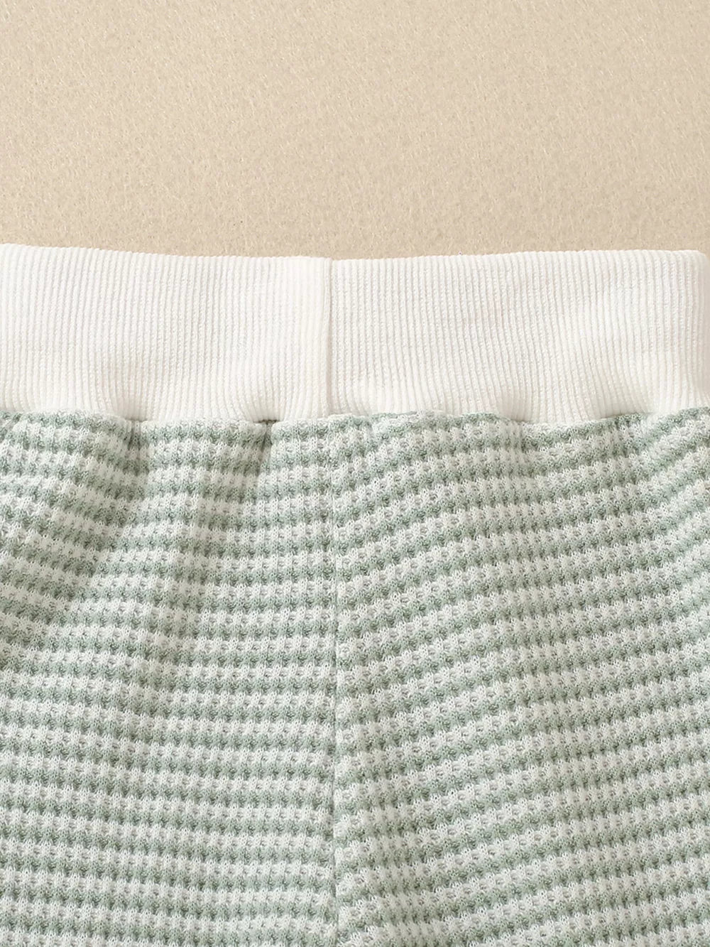Light green striped baby set with waffle knit fabric and white ribbed waistband.