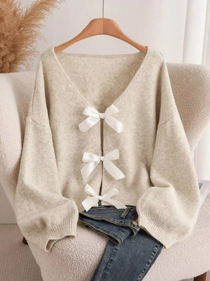 Khaki V-neck cardigan with balloon sleeves and three white bow-knot details.