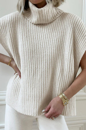 Sleeveless ribbed turtleneck sweater in ivory, featuring a chunky knit texture and relaxed fit.