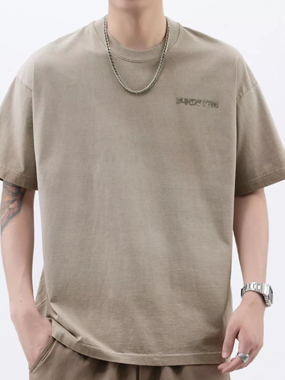 Men's Khaki cotton t-shirt with round neck and subtle chest graphic detail.