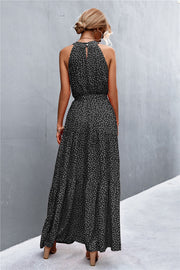 Black polka dot halter neck maxi dress with tiered skirt and back keyhole detail.