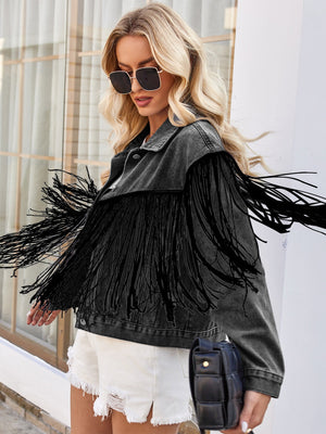 Black denim trucker jacket with dramatic fringe trim and a relaxed fit.