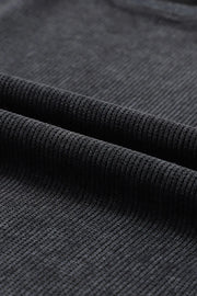 Black ribbed sweatshirt fabric detail showing texture and weave