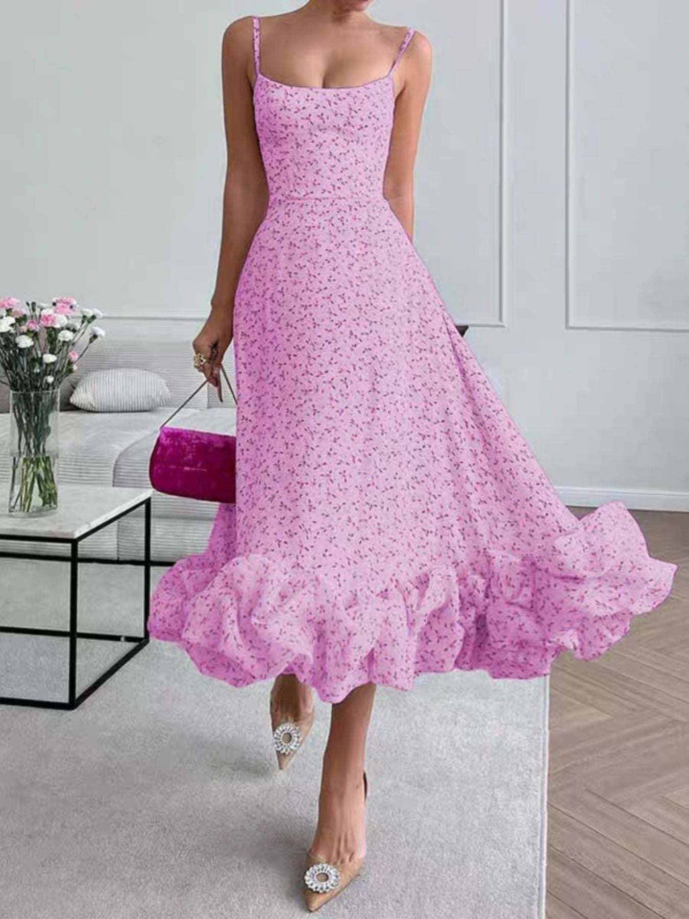 Pink floral ruffle hem midi dress with spaghetti straps and a flowing skirt.