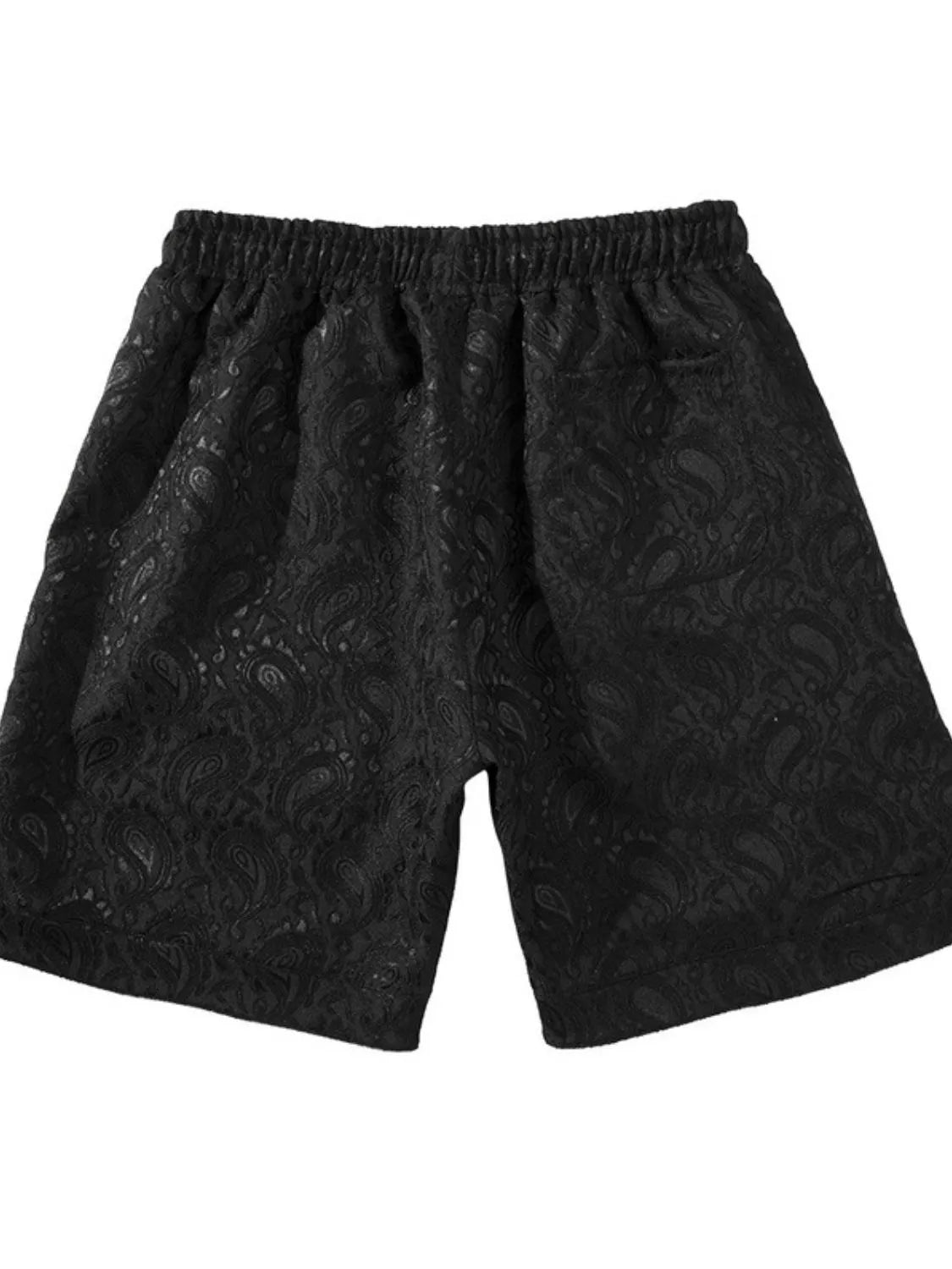Black jacquard paisley shorts with elastic waist and zip pocket detail.