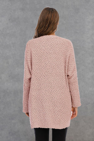 Watermelon pink textured cocoon cardigan with patch pockets, long sleeves, and open front.