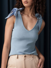 Light blue ribbed knit tank top with bow shoulder details and a V-neck.
