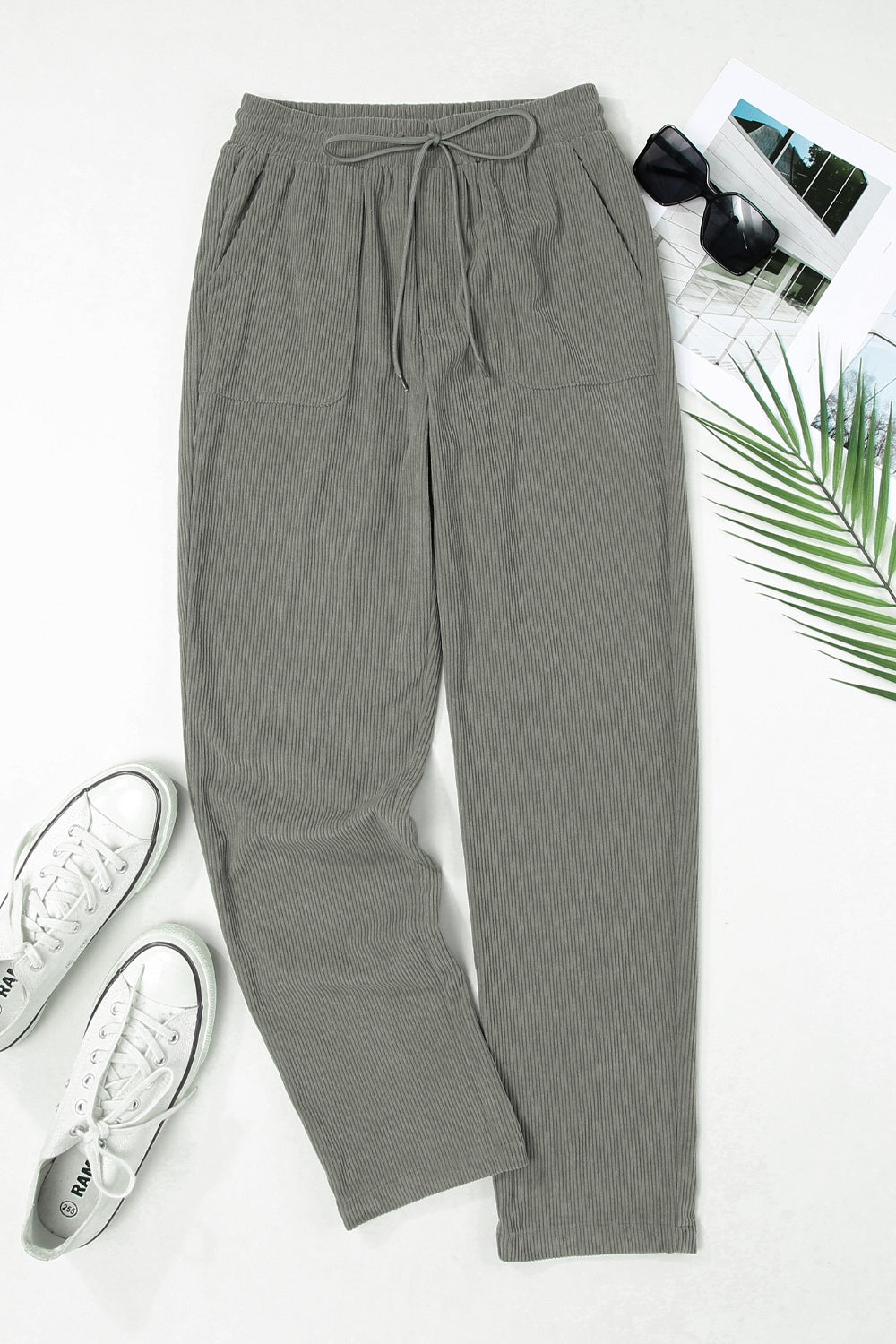 Corduroy drawstring trousers in dark gray with slant pockets and a relaxed fit.