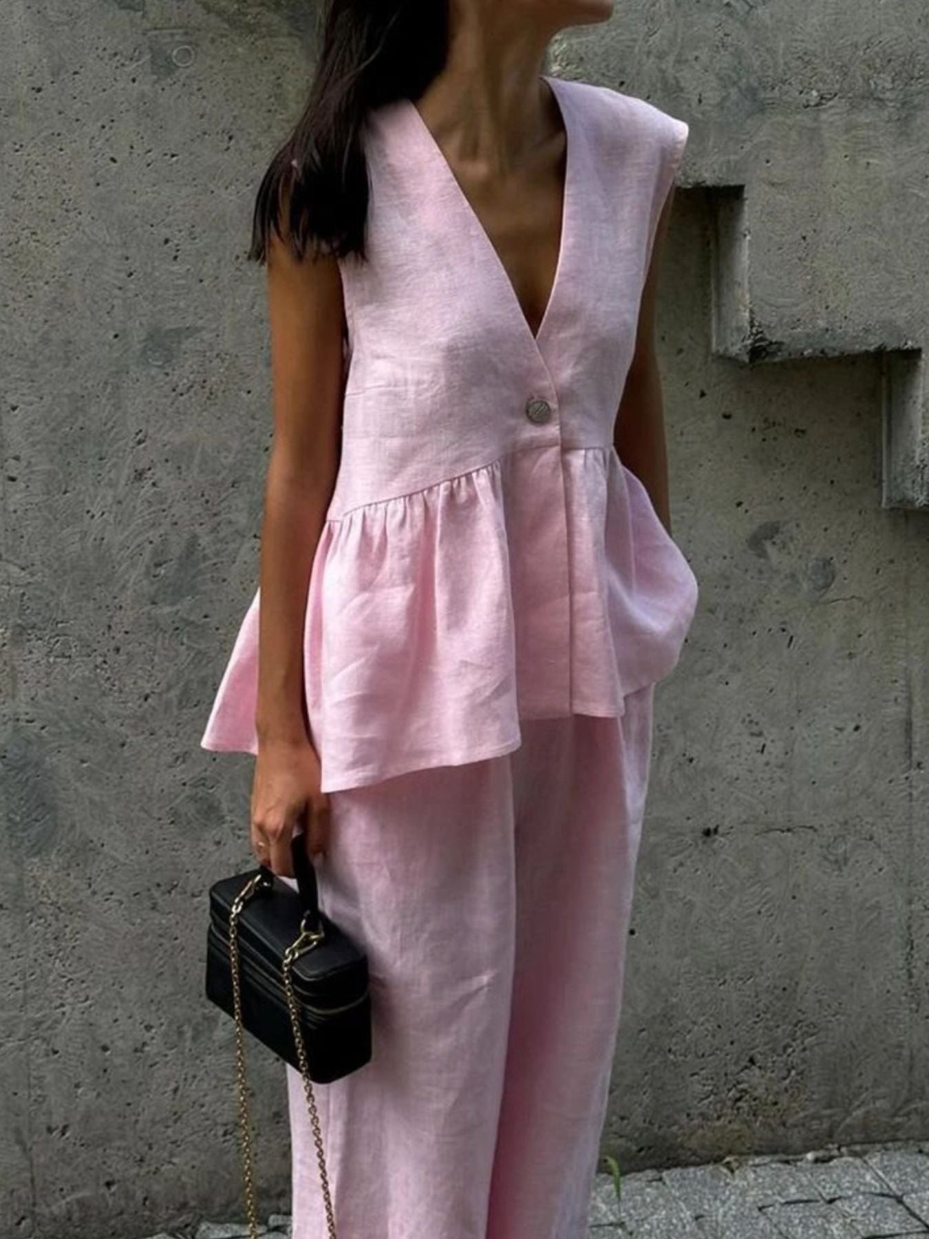 Blush pink sleeveless peplum top and wide-leg pants set in cotton.