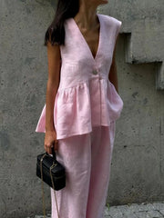Blush pink sleeveless peplum top and wide-leg pants set in cotton.