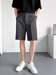 Belted dark gray chino shorts with pleats and a relaxed fit.