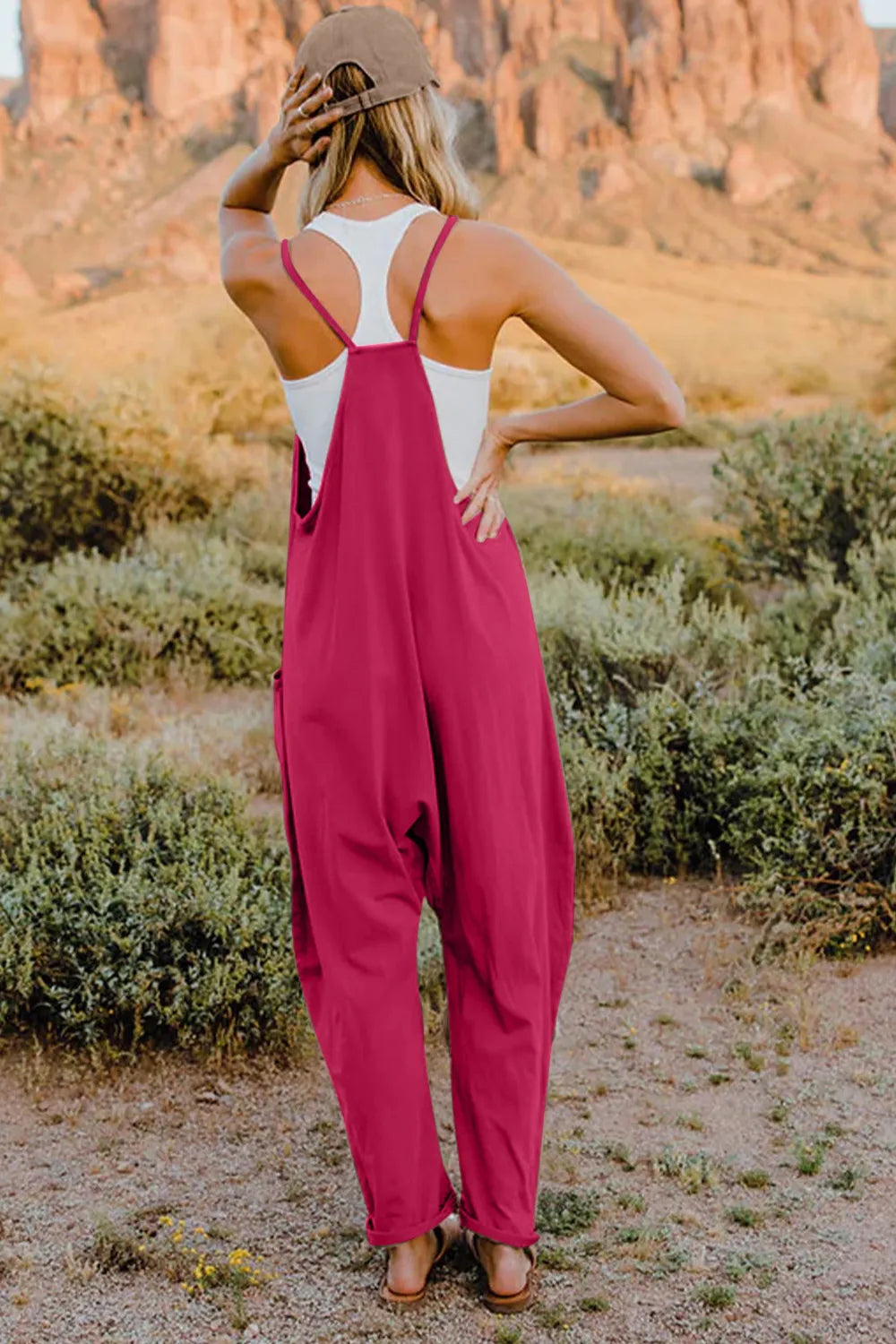 Hot Pink cotton jumpsuit with wide legs, pockets, and spaghetti straps.