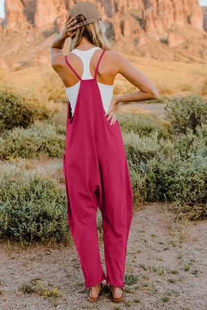 Hot Pink cotton jumpsuit with wide legs, pockets, and spaghetti straps.