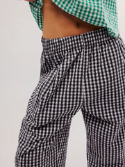 Black gingham check wide-leg pants with pockets and elastic waistband.