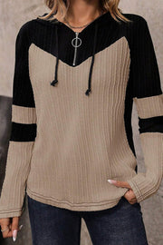 Colorblock ribbed zip-neck hoodie in mocha and black with a chevron pattern and contrast sleeve stripes.