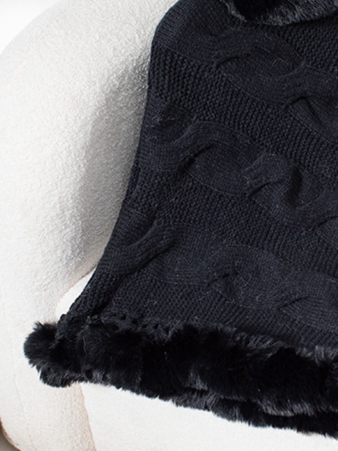 Black cable knit poncho with faux fur trim detail