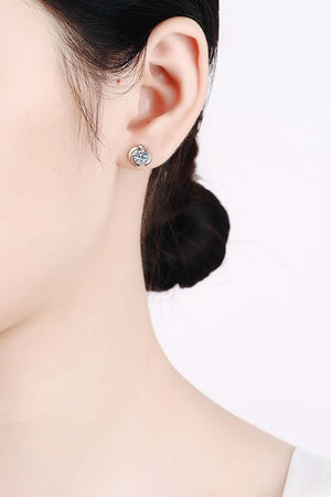Silver crystal stud earrings with a swirling halo design.