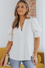 White puff sleeve v-neck blouse with smocking detail on sleeves