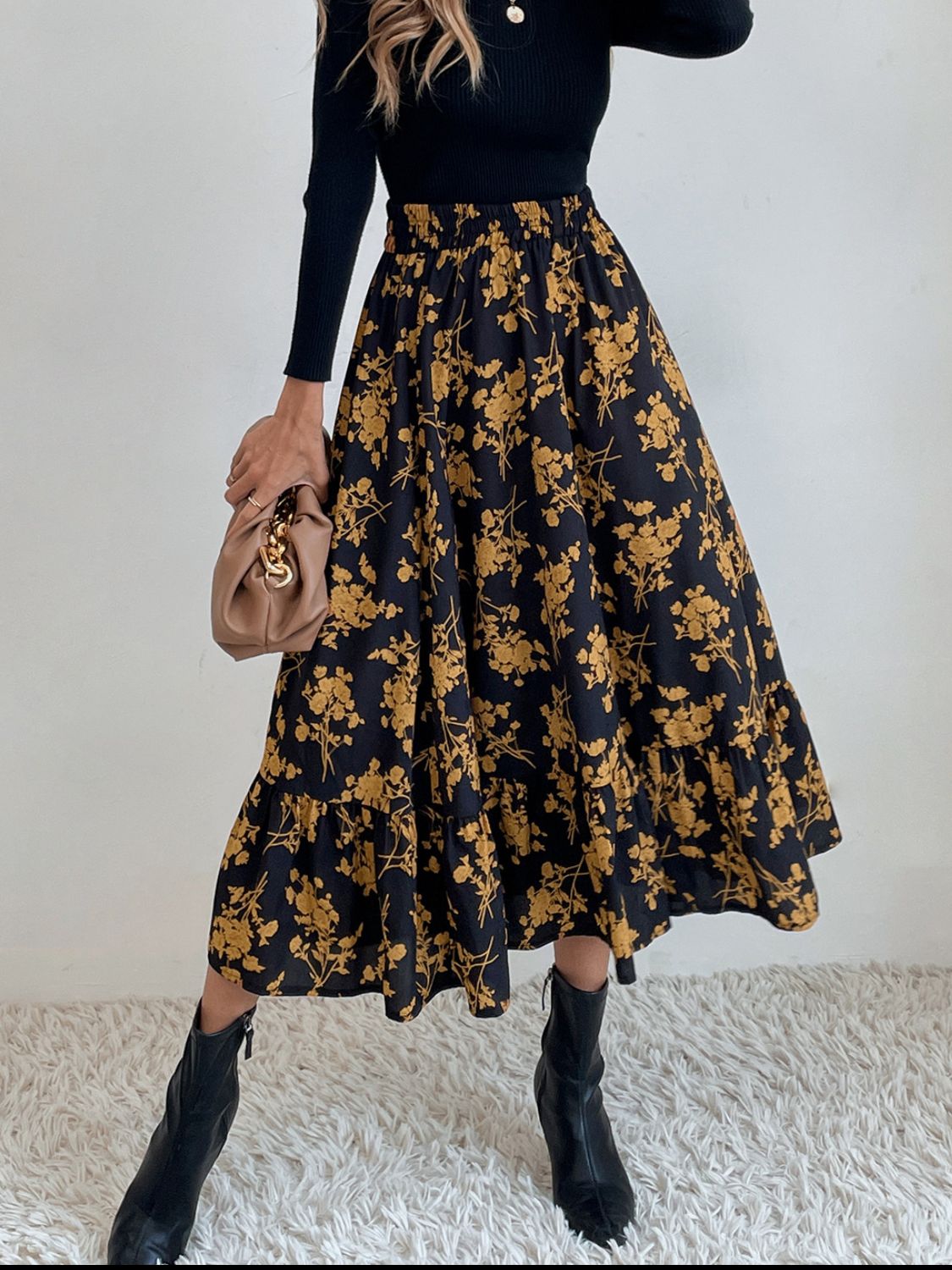 Tiered midi skirt in black with yellow floral print and ruffled hem.