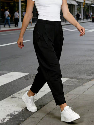Black harem maternity joggers with pockets and pinstripe detail.