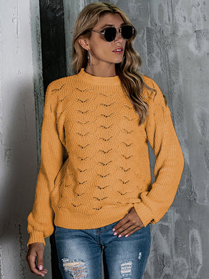 Mustard openwork knit crew neck pullover sweater with balloon sleeves and a textured pattern.