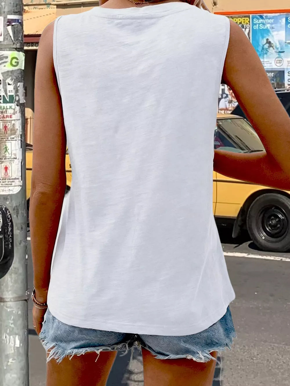 White V-neck tank top with pocket detail, casual basic style.