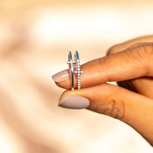 Silver double cross band ring with small diamonds on one cross.