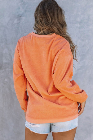 Tangerine corduroy sweatshirt with crew neck and long sleeves, shown from the back.