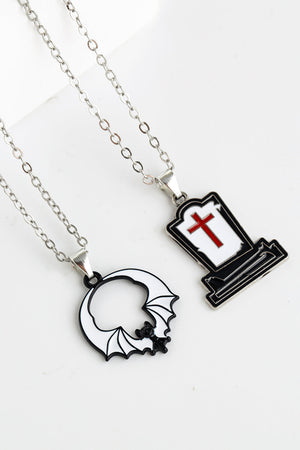 Spooky Season enamel pendant necklaces: tombstone with red cross and bat outline.