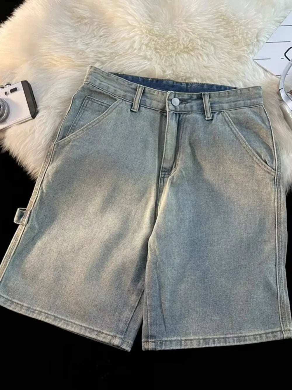 Men's light wash denim shorts with a high waist and wide leg.