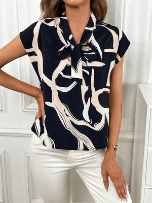 Black abstract print cap-sleeve top with a tie-neck detail.