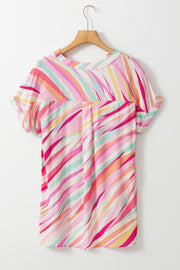 Blush pink blouse with a colorful prismatic stripe pattern and cuffed short sleeves.